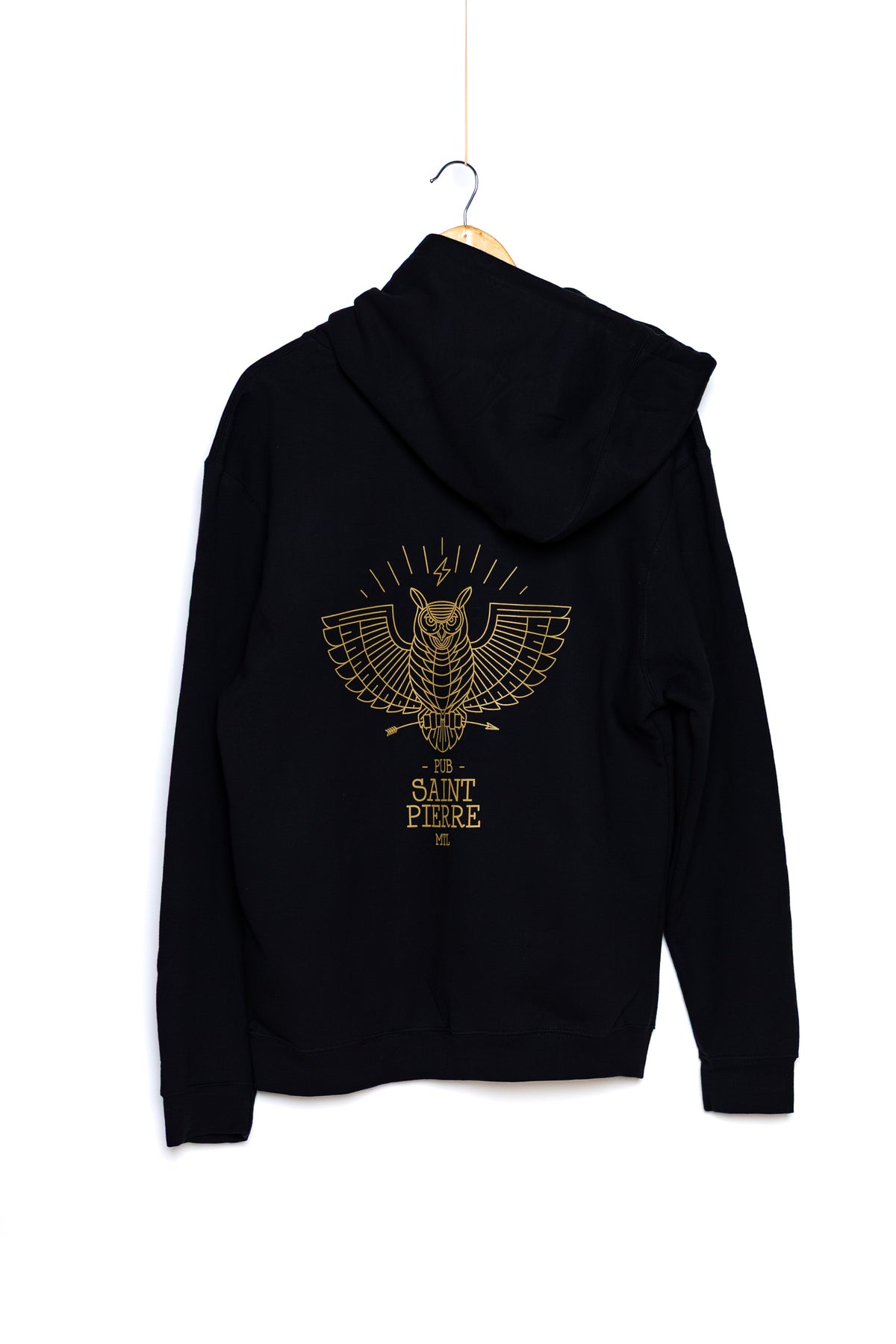 Back of the black Pub Saint Pierre pullover hoodie on a white background, gold winged owl and wordmark