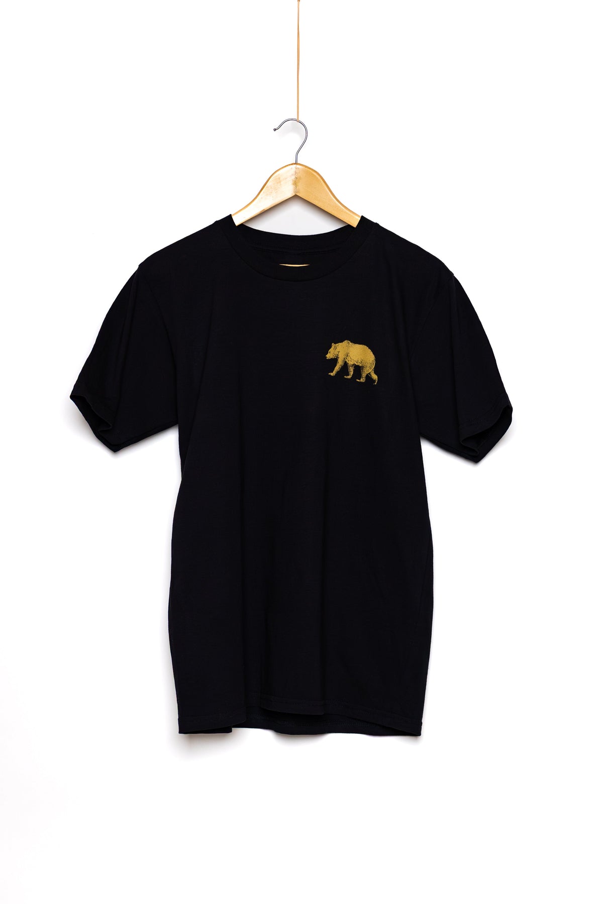 Front of the black Pub Saint Pierre t-shirt on a white background, gold bear at the chest